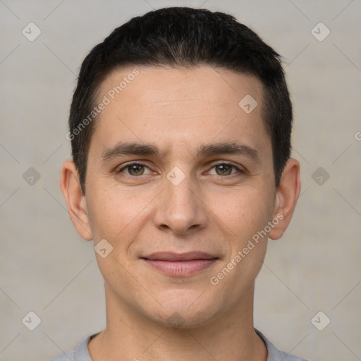 Joyful white young-adult male with short  black hair and brown eyes