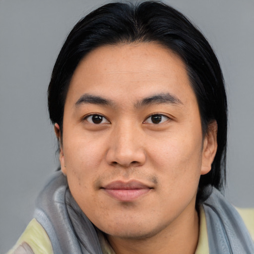 Joyful asian young-adult male with short  black hair and brown eyes