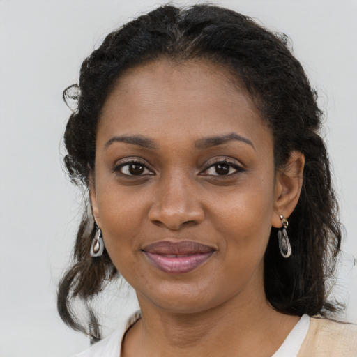 Joyful black young-adult female with medium  brown hair and brown eyes