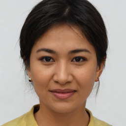 Joyful asian young-adult female with medium  brown hair and brown eyes