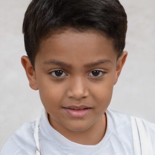 Joyful white child male with short  brown hair and brown eyes