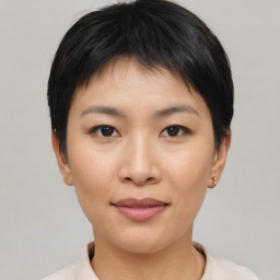 Joyful asian young-adult female with short  black hair and brown eyes