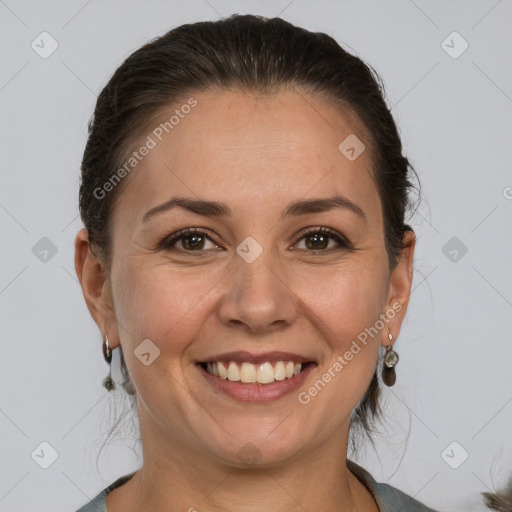 Joyful white adult female with medium  brown hair and brown eyes