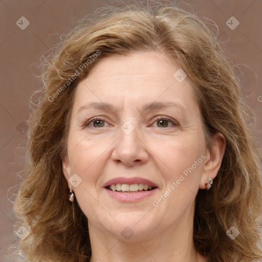 Joyful white adult female with long  brown hair and grey eyes