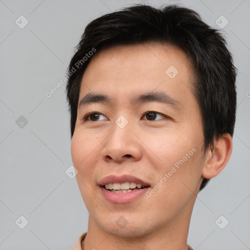 Joyful asian young-adult male with short  brown hair and brown eyes