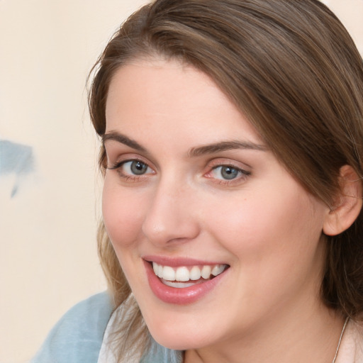 Joyful white young-adult female with long  brown hair and blue eyes