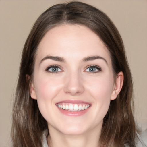 Joyful white young-adult female with medium  brown hair and grey eyes