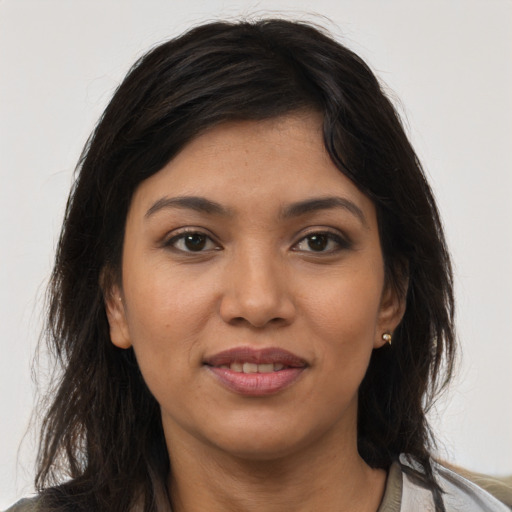 Joyful latino young-adult female with medium  brown hair and brown eyes