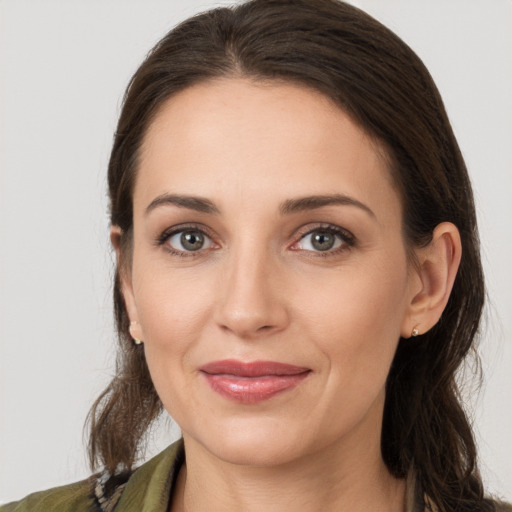 Joyful white young-adult female with medium  brown hair and brown eyes