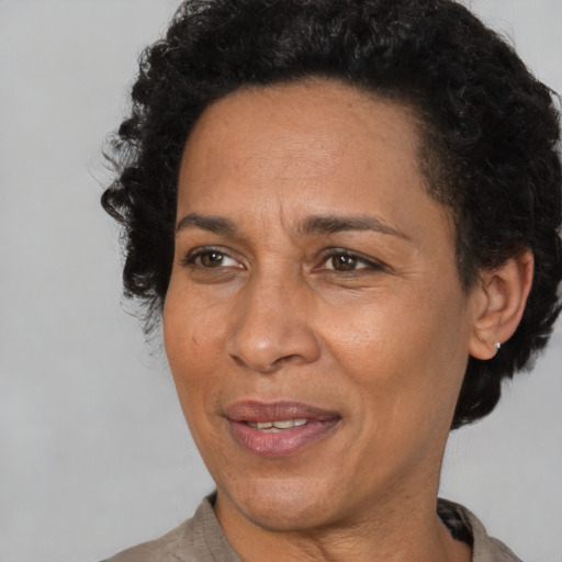 Joyful latino adult female with short  brown hair and brown eyes