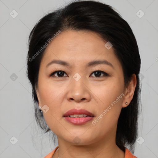 Joyful asian adult female with medium  brown hair and brown eyes