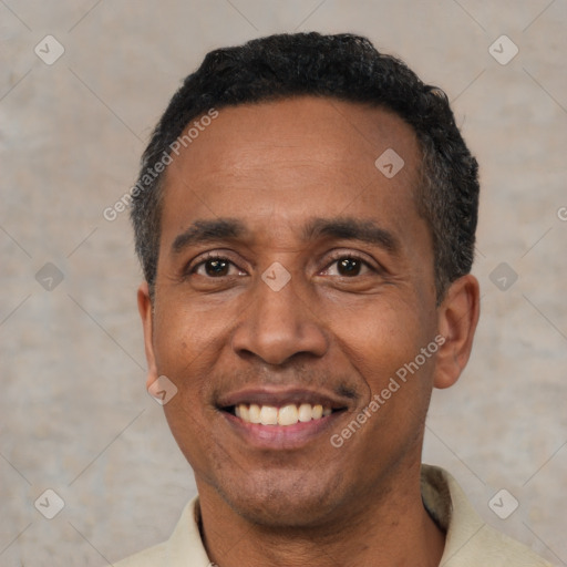 Joyful latino adult male with short  black hair and brown eyes