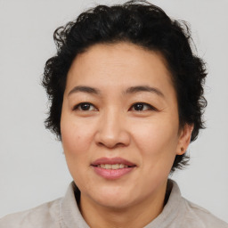 Joyful asian adult female with short  brown hair and brown eyes