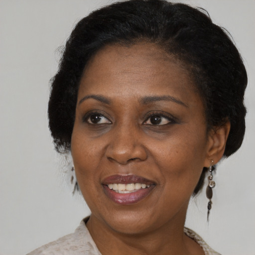 Joyful black adult female with medium  brown hair and brown eyes
