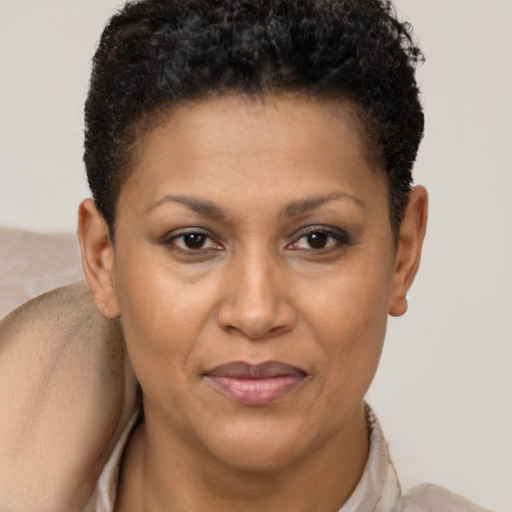 Joyful black adult female with short  brown hair and brown eyes
