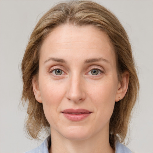 Joyful white adult female with medium  brown hair and grey eyes