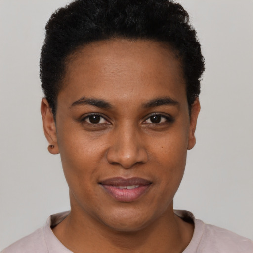 Joyful black young-adult female with short  black hair and brown eyes