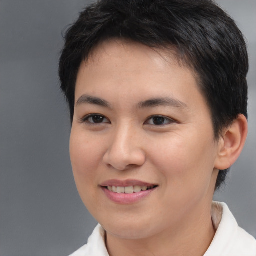 Joyful asian young-adult female with short  brown hair and brown eyes