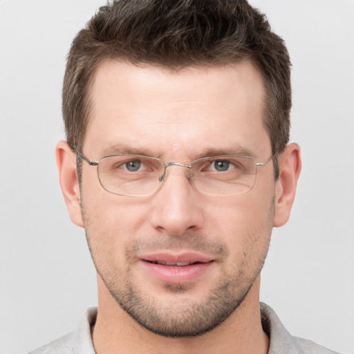 Joyful white adult male with short  brown hair and grey eyes