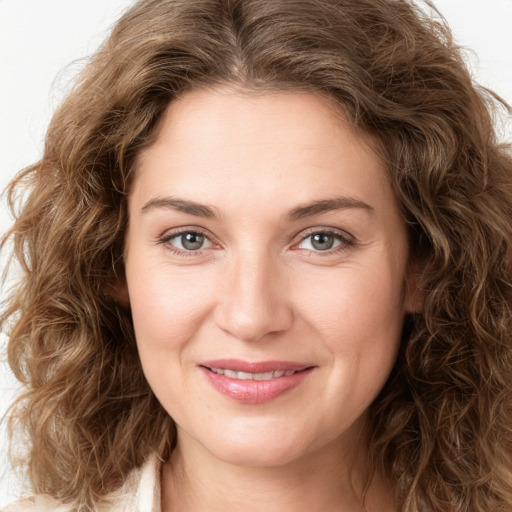 Joyful white young-adult female with long  brown hair and green eyes