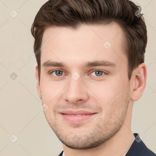 Joyful white young-adult male with short  brown hair and grey eyes