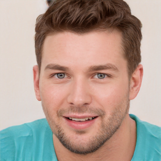 Joyful white young-adult male with short  brown hair and grey eyes