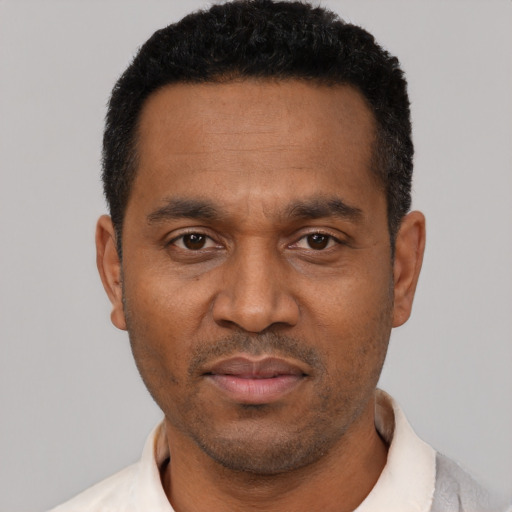 Neutral latino adult male with short  black hair and brown eyes