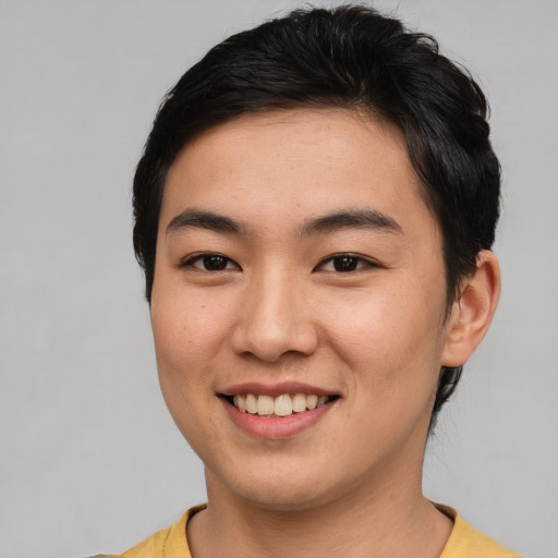 Joyful asian young-adult male with short  brown hair and brown eyes
