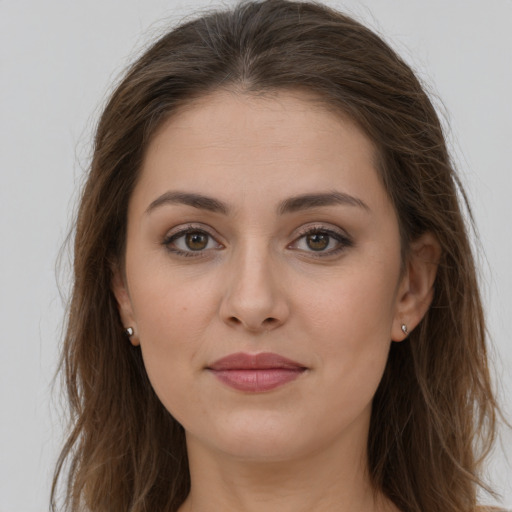 Joyful white young-adult female with long  brown hair and brown eyes