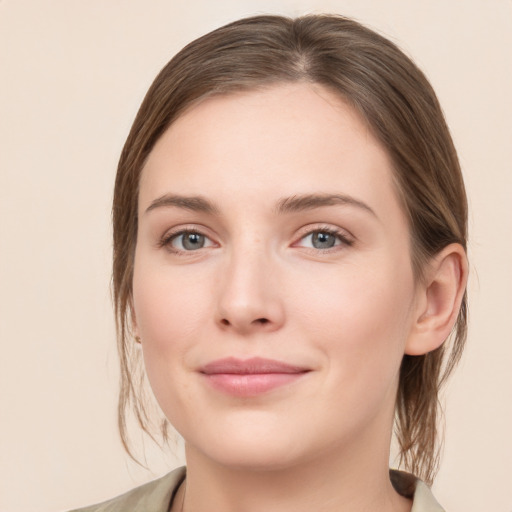 Joyful white young-adult female with medium  brown hair and grey eyes