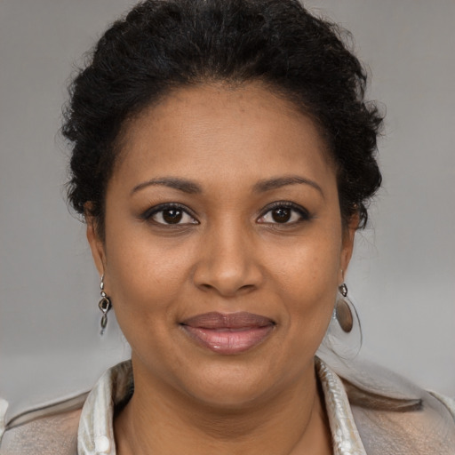 Joyful black adult female with short  brown hair and brown eyes