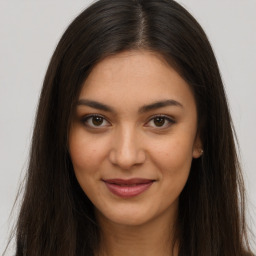 Joyful latino young-adult female with long  brown hair and brown eyes