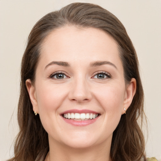 Joyful white young-adult female with long  brown hair and grey eyes