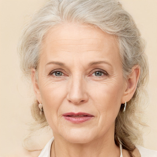 Joyful white middle-aged female with medium  blond hair and blue eyes