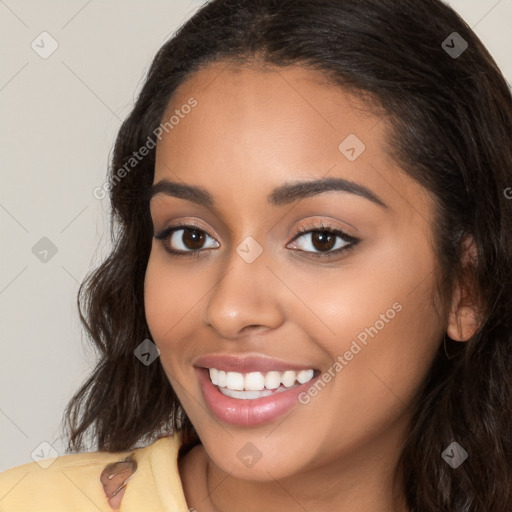 Joyful latino young-adult female with long  brown hair and brown eyes