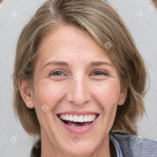 Joyful white adult female with medium  brown hair and blue eyes