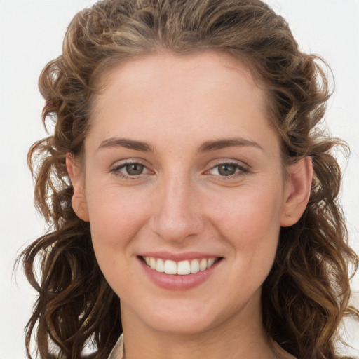 Joyful white young-adult female with long  brown hair and blue eyes