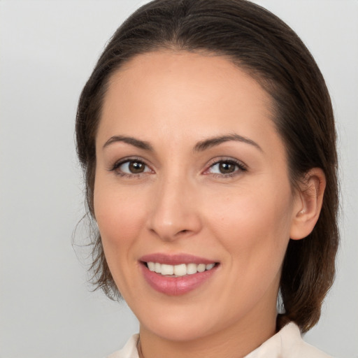 Joyful white young-adult female with medium  brown hair and brown eyes