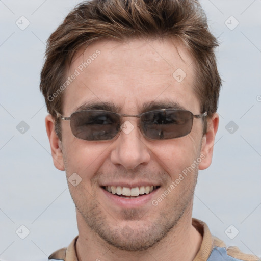 Joyful white adult male with short  brown hair and grey eyes