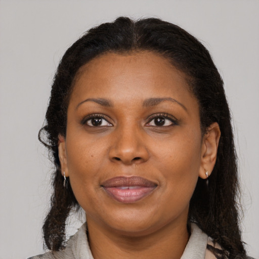 Joyful latino adult female with medium  brown hair and brown eyes