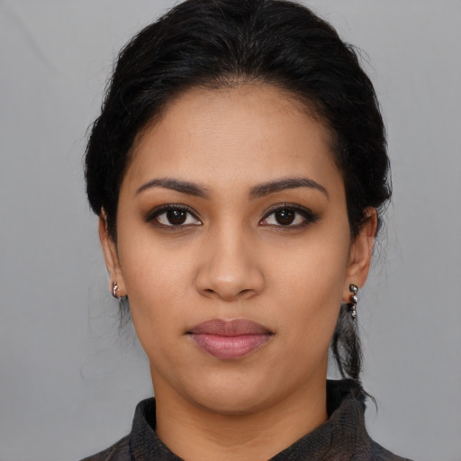 Joyful latino young-adult female with medium  black hair and brown eyes