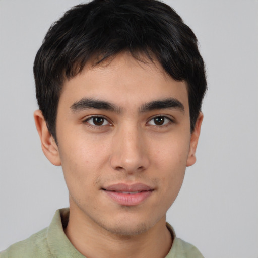 Joyful asian young-adult male with short  brown hair and brown eyes