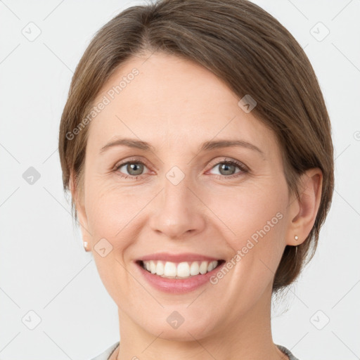 Joyful white young-adult female with medium  brown hair and grey eyes