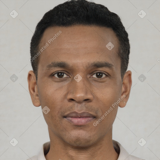 Joyful black young-adult male with short  black hair and brown eyes
