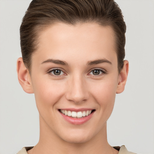 Joyful white young-adult female with short  brown hair and brown eyes