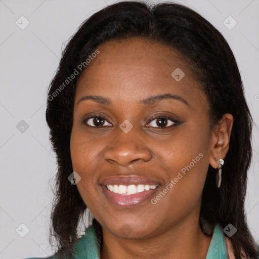 Joyful black young-adult female with long  brown hair and brown eyes