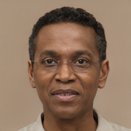 Joyful black adult male with short  black hair and brown eyes
