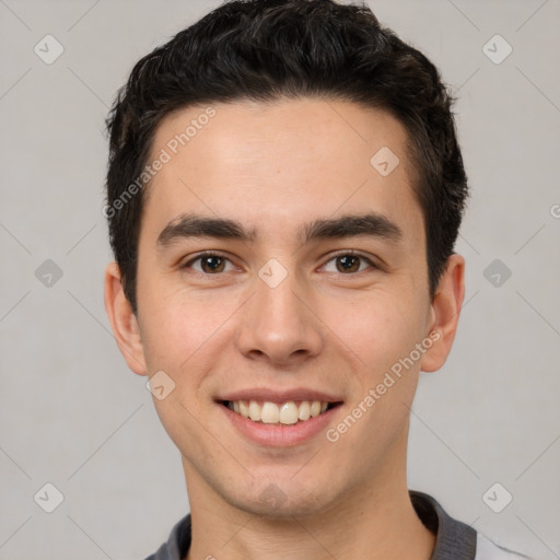 Joyful white young-adult male with short  black hair and brown eyes