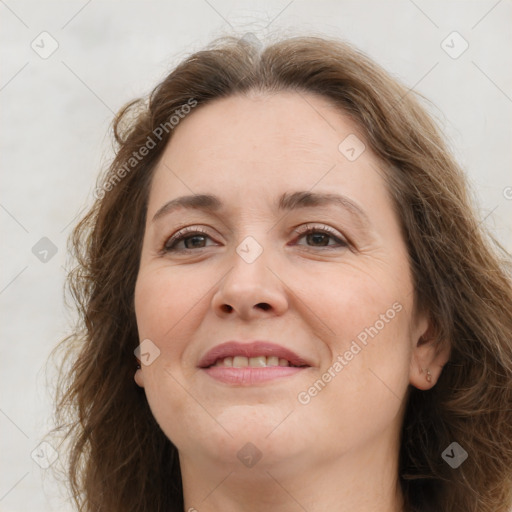 Joyful white adult female with long  brown hair and grey eyes