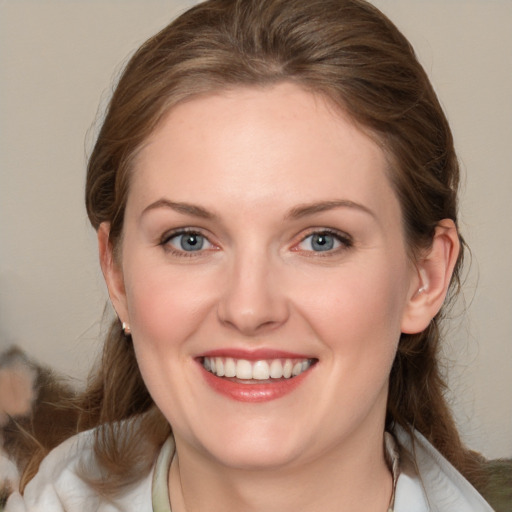 Joyful white young-adult female with medium  brown hair and blue eyes